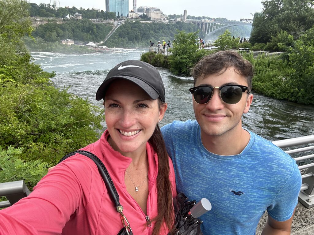 Mother and son selfie in workout clothes, with Niagara Falls behind