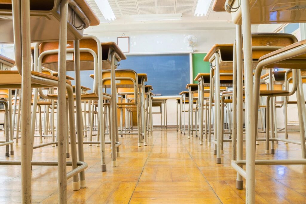 classroom; view from the floor looking forward to the front with rows of desks on either side