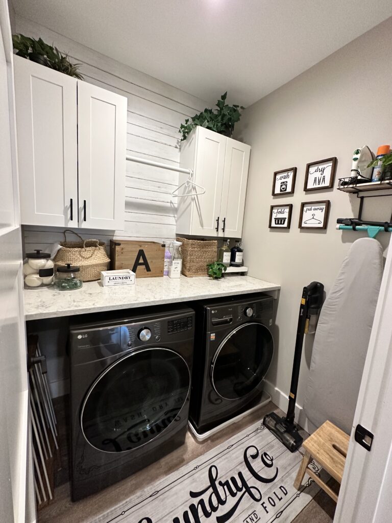 Small farmhouse laundry room with shiplap , black washer/dryer