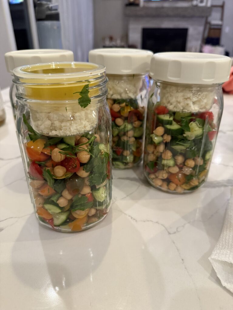 Mediterranean Salad in Mason Jars with cheese & dressing in drop in separate containers. So cute & functional